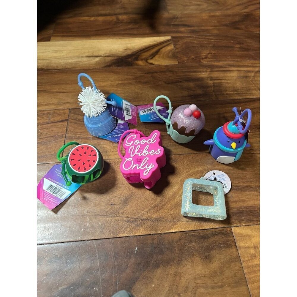 Lot of 6 hand sanitizer cases.   Good vibes, cupcake, penguin, melon